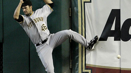 Pirates right fielder Garrett Jones falls after leaping at the wall as he tries to catch a two-run triple hit by Astros third baseman Geoff Blum during the first inning last night.