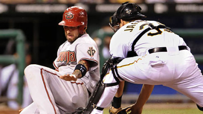 Diamondbacks infielder Ryan Roberts slides into home plate safely as Pirates catcher Jason Jaramillo can't hold on to the ball in the eighth inning Wednesday.