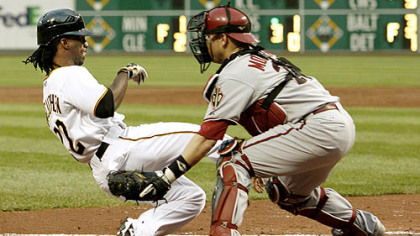 Pirates outfielder Andrew McCutchen scores from first base on a double by Lastings Milledge as Diamondbacks catcher Miguel Montero waits for the throw in the third inning.