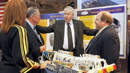 Rep. John P. Murtha, D-Johnstown, center, speaks on Friday with, from left, Karen Stiles, Jack Sweet and Joe Calin of Argon, an electronic defense contractor, at the Showcase for Commerce at the Cambria County War Arena in Johnstown.
More than 150 vendors fill the Cambria County War Memorial for the showcase.