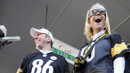 Kayla Kennell and Stephen Borosky joined the throngs of Steeler fans in the Strip District earlier today. Ms. Kennell's black and gold attire included a skirt she fashioned from Terrible Towels.