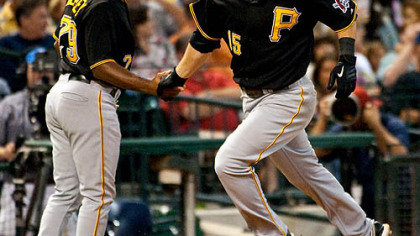 Pirates third baseman Andy LaRoche, right, is congratulated by third base coach Tony Beasley after hitting a solo home run during the fifth inning.