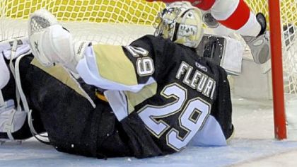 Detroit's Henrik Zetterberg gets hung up on the crossbar after crashing the net against Marc-Andre Fleury. Zetterberg was called for interference on the play in the first period.