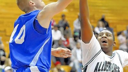 Allderdice High School's Deion Nesbitt goes up to block a shot by Perry's Andrew Forse in the City League championship game at the Palumbo Center.