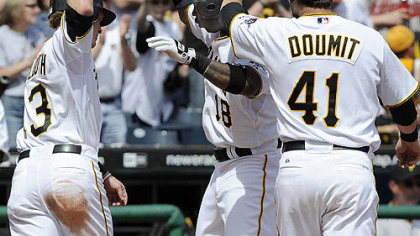 Pirates' Craig Monroe is greeted at home by Nate McLouth and Ryan Doumit after hitting a three run homer in the sixth against the Braves at PNC Park.
