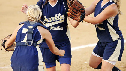 Catcher Alex Fleck, left, winning pitcher Ally Vrcek and second baseman Ashley Dolan, right, celebrate after the final out as Franklin Regional remains undefeated with a victory against Trinity in the WPIAL Class AAA championship game.