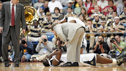 Pitt's DeJuan Blair is attended to after colliding with Oklahoma State's Byron Eaton in the first half.