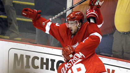 Detroit's Darren Helm, top, celebrates scoring the game-winning goal against the Chicago Blackhawks in overtime of Game 5 of the NHL hockey Western Conference finals last night in Detroit.
