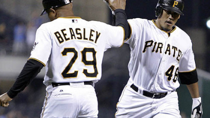 Pirates outfielder Delwyn Young  rounds third to greetings from third base coach Tony Beasley after hitting a three-run, first-inning home run off Brewers pitcher Mike Burns last night at PNC Park.