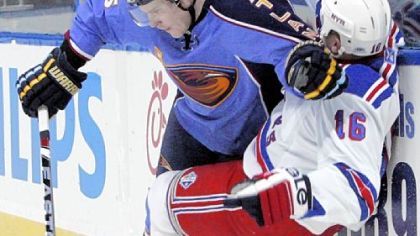 Thrashers defenseman Anssi Salmela knocks Rangers left winger Sean Avery into the boards Thursday in Atlanta.