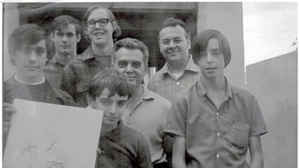 Photo of the very first committee members of the San Diego Comic-Con (except for Mike Towry, who is not pictured). It was taken in the fall of 1969 at the home of Jack Kirby. 
Left to right are:
Dan Stewart (holding drawing), Bob Sourk, Richard Alf, Barry Alfonso (in front, holding drawing), Jack Kirby, Shel Dorf and Wayne Kincaid. (Wayne was not a Comic-Con member; he was just along for the visit.)
The photo comes from the collection of Richard Alf.