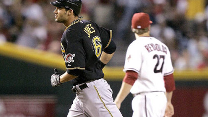 Pirates outfielder Garrett Jones rounds third after hitting a two-run home run as Diamondbacks third baseman Mark Reynolds looks away during the fifth inning.