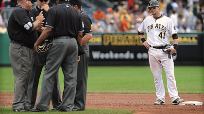 Pirates catcher Ryan Doumit stands on second base as the umpires discuss if Doumit's ball was a double or a home run against the Brewers at PNC.  Doumit was given the home run.