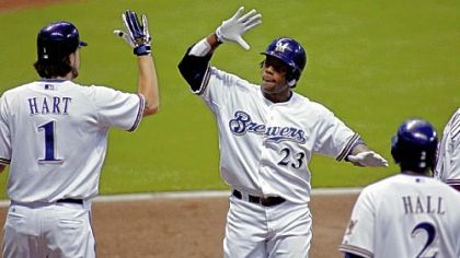 The Brewers' Rickie Weeks is congratulated by Corey Hart after hitting a three-run home run against Jeff Karstens last night.