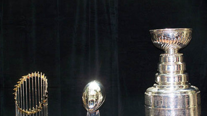 From left, the World Series, Vince Lombardi (NFL) and the Stanley Cup (NHL) championship trophies.