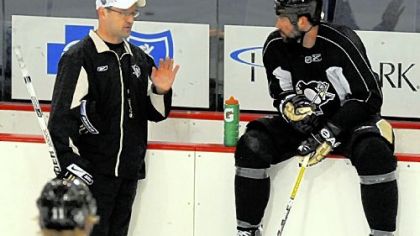 Penguins head coach Dan Bylsma (left) talks with forward Bill Guerin during practice at the Mellon Arena for their Stanley Cup Finals Game 1 with the Detroit Red Wings tomorrow.