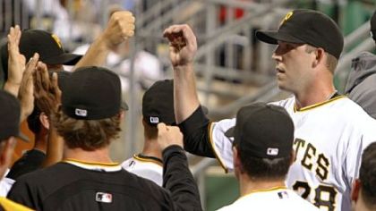 Paul Maholm,  is greeted by teammates in the dugout. Maholm was the winning pitcher in the Pirates' 3-1 victory.