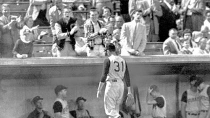 Pirates pitcher Harvey Haddix takes the sad walk back to the Pirates' dugout.