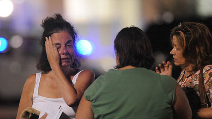 An unidentified woman who was inside LA Fitness during the shooting is comforted by friends in the parking lot outside last evening.