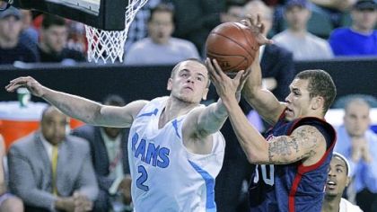 Rhode Island's Ben Eaves and Duquesne's Bill Clark fight for the ball in the first half last night in the Atlantic 10 tournament in Atlantic City, N.J.