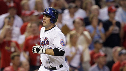 Mets third baseman David Wright scores on a hit by Cardinals catcher Yadier Molina during second inning.