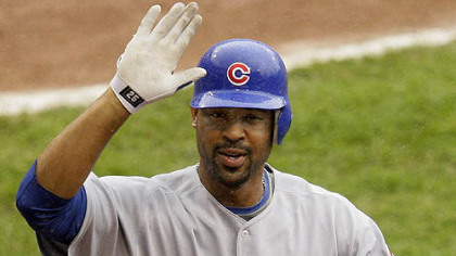 Cubs first baseman Derrek Lee, top, is greeted by teammate Milton Bradley after hitting a two-run homerun off Pirates pitcher Daniel McCutchen during the third inning.