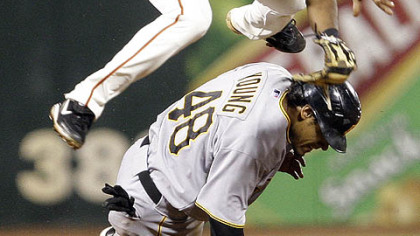 Pirates outfielder Delwyn Young breaks up a double play with Giants second baseman Eugenio Velez during the seventh inning.