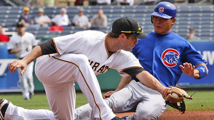 Pirates third baseman Neil Walker takes the late throw from right fielder Garrett Jones as Cubs outfielder Kosuke Fukudome advances to third on single by Cubs shortstop Ryan Theriot in the second inning.