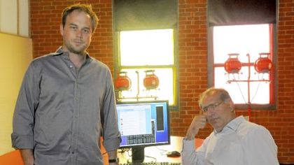 Geoff Barnes, left, an Information Solutions Architect, and Abu Noaman, CEO of Elliance, an Internet marketing agency in the Confluence building on the North Shore.  The company is considering a project in which it will invite Twitter messages that people want to send to the G20 leaders to be flashed in Morse Code.
