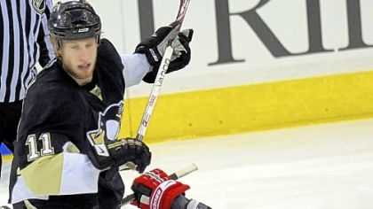 The Hurricanes' Eric Staal is tripped by his brother Jordan Staal in the third period last night.