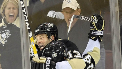 Bill Guerin gets a hearty hug from teammate Chris Kunitz after scoring the winning goal.