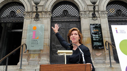 Barbara Mistick, president and director of the Carnegie Library of Pittsburgh, calls attention to the entrance proclaiming "Free to the people," as she speaks of the library''s funding issues and lack of dedicated revenue sources. Continued funding shortfalls may require cuts in services and library locations.