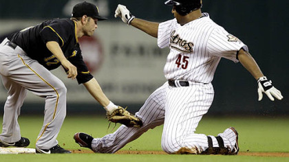 Houston Astros' Carlos Lee (45) is tagged out at second base by Freddy Sanchez, left, while trying to stretch a single into a double during the fifth inning of yesterday's game in Houston.