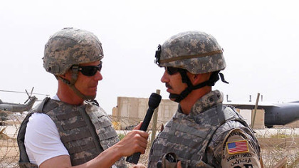 Master Sgt. Jeffrey Perz, right, of the Pennsylvania Air National Guard, is interviewed by announcer Rob Powers outside Sather Air Base in Iraq.