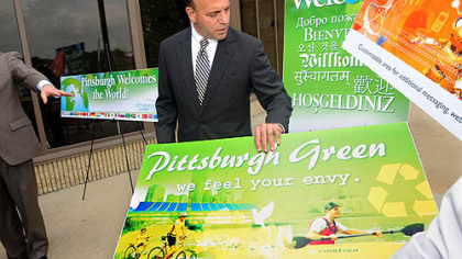 Allegheny County Executive Dan Onorato unveils signs yesterday that will be posted around the region during next month's G-20 summit. n For a video report, go to post-gazette.com