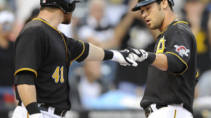 Pirates outfielder Garrett Jones, right, is greeted at home by catcher Ryan Doumit after hitting a solo home run in the first inning.