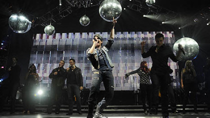Adam Lambert sings with his fellow former American Idol contestants at Mellon Arena Saturday night.
