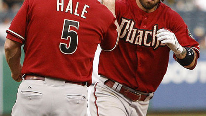 Diamondbacks infielder Ryan Roberts rounds third to greetings from coach Chip Hale after hitting a two-run home run off Pirates pitcher Zach Duke in the third inning.