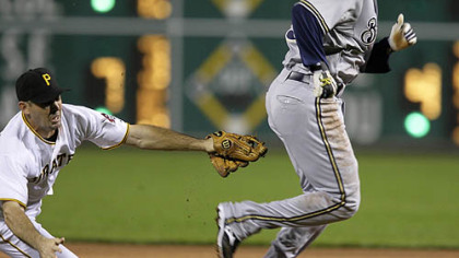 Pirates shortstop Jack Wilson tags out Brewers second baseman Felipe Lopez to end a first inning rundown between first and second.