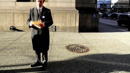 Pittsburgh mayoral candidate Patrick Dowd reviews his notes before addressing the media at the corner of Forbes Avenue and Grant Street, Downtown, today.