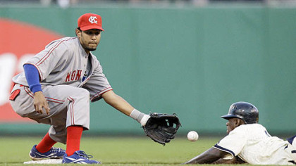 Royals shortstop Tony Pena, left, takes the throw from catcher Miguel Olivo as Pirates outfielder Nyjer Morgan attempts to steal second base in the fifth inning. Umpire Tom Hallon called Morgan out on the play.