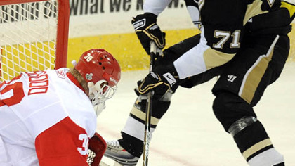 Chris Osgood makes a stop on Evgeni Malkin in Game 4. Osgood is 3-0 at home in this series and 0-2 on the road.