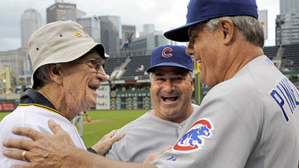 Former Pirates manager Chuck Tanner greets Cubs manager Lou Piniella, right, and first base coach Matt Sinatro after a ceremony honoring the 100th anniversary of Forbes Field last night.