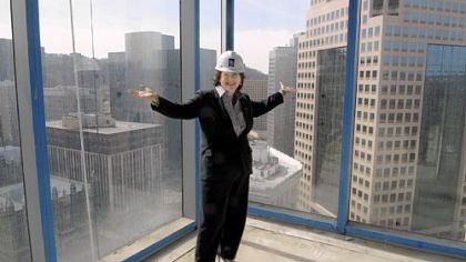 Helen Hanna Casey, president of Howard Hanna Real Estate Services, shows off the million-dollar view from the 22nd floor of The Residences at Three PNC Plaza, above.