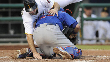Pirates shortstop Jack Wilson reaches for home plate as he's tagged out by Cubs catcher Geovany Soto in the fifth inning last night. Wilson apologized for remarks he made concerning team management.