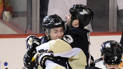 Kris Letang is congratulated by teammate Bill Guerin after shooting the winning goal in overtime against the Capitals in Game 3 of the second-round of the Stanley Cup Playoffs series tonight at Mellon Arena.