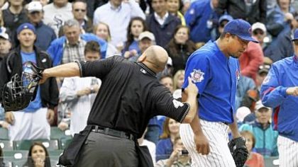 Home plate umpire Mark Carlson, left, ejects Chicago Cubs' starting pitcher Carlos Zambrano, center, as Cubs manager Lou Piniella, right, comes to his aid during the seventh inning of last night's game against the Pirates at Wrigley Field in Chicago. Zambrano argued that he tagged the Pirates' Nyjer Morgan at home plate.