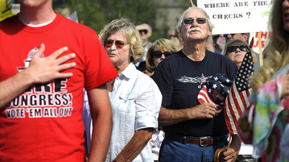 From left, Medge Boyer, of Shaler; Paul Jones, of Finleyville, and Juanita Martini, of Elizabeth, recite the Pledge of Allegiance at a "tea party" rally at North Boundary Park in Cranberry yesterday afternoon.