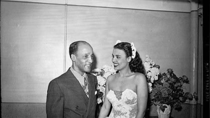 Teddy Horne, and his daughter Lena Horne wearing sequined strapless dress, standing
in Stanley Theatre, c. 1944.