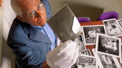 Charles A. "Little Teenie" Harris, the curator of "Documenting Our Past: The Teenie Harris Archive Project, Part Three," reviewing his father's images.
